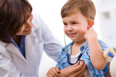 A Child with a doctor hearing his heartbeat