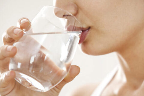 woman drinking water with glass