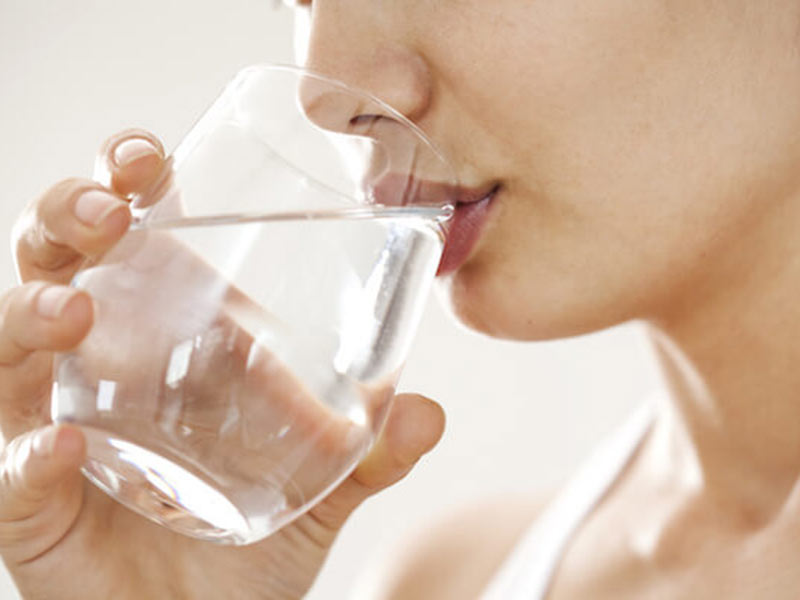 woman drinking water with glass