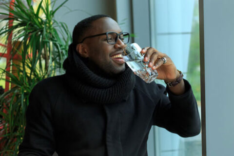 A man drinking a glass of water