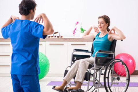 a nurse helping a women in exercising