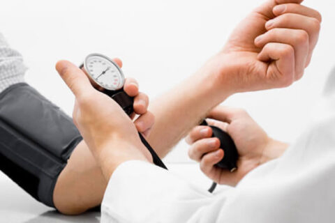 A Doctor checking blood pressure of a patient