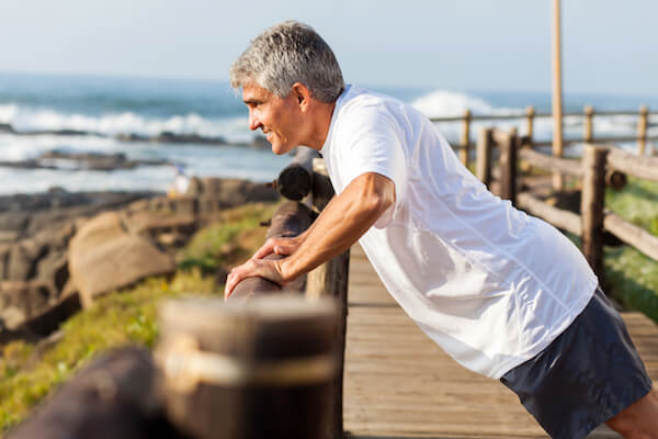 A Man doing pushup at a wooden bridge