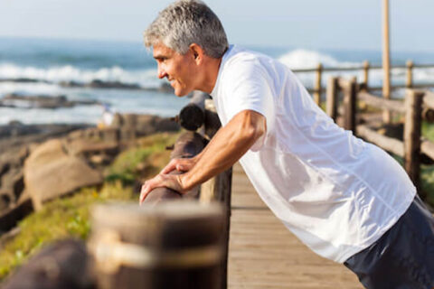 A Man doing pushup at a wooden bridge