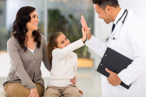 A Doctor and a child giving high five