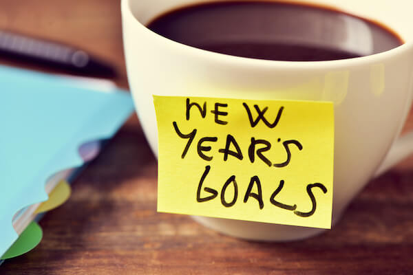 Coffee Cup with a new year goals sticky note