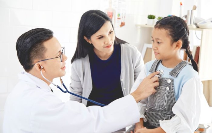 Doctor checking a small girl
