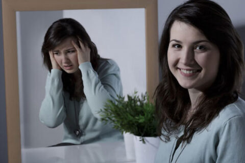 mirror and girl smiling and depressed on same time