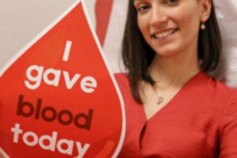 The lady with a I gave blood today poster