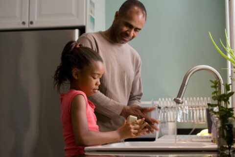 man and child working in the kitchen