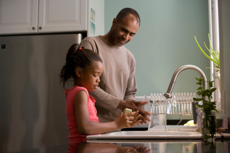 man and child working in the kitchen