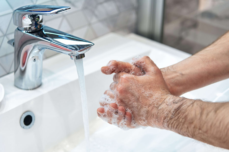 Man is washing hands with soap