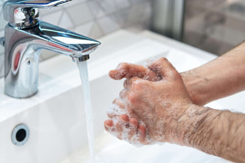 Man is washing hands with soap