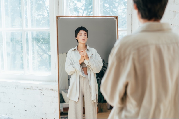 woman looking in mirror