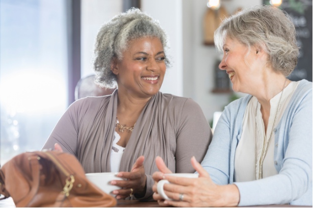 Two women drinking coffee and talking