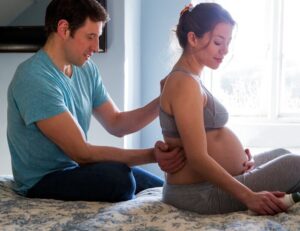 Husband helping Pregnant Wife with Morning Sickness