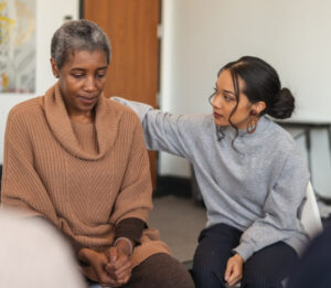 Depressed woman discussing her anxiety post-addiction recovery in a therapy session