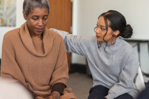 Depressed woman discussing her anxiety post-addiction recovery in a therapy session