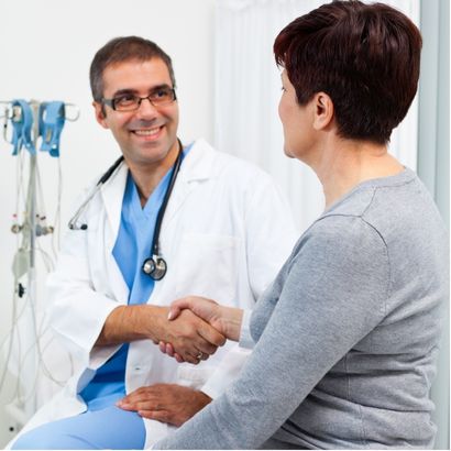 Doctor helping patient in an exam room