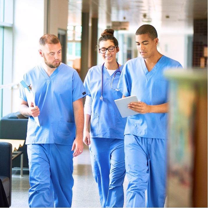 Team of medical providers talking in hallway
