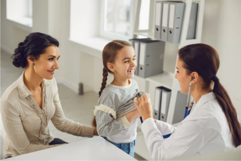 Pediatrician with young patient and mother