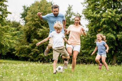 Family playing soccer