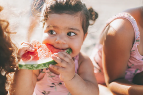 Toddler eating watermelon
