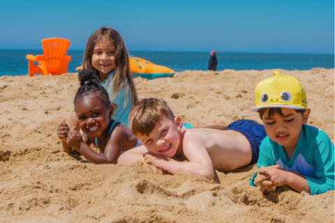 Kids playing in the sand at the beach