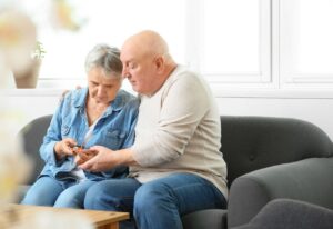 A couple using a blood glucose device