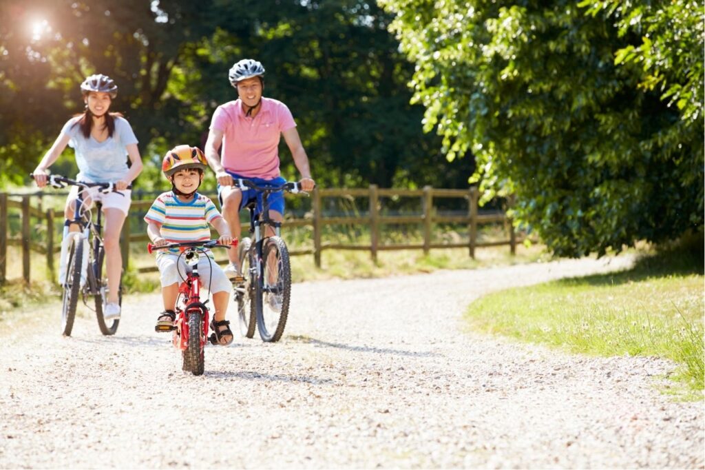 family of three riding bikes