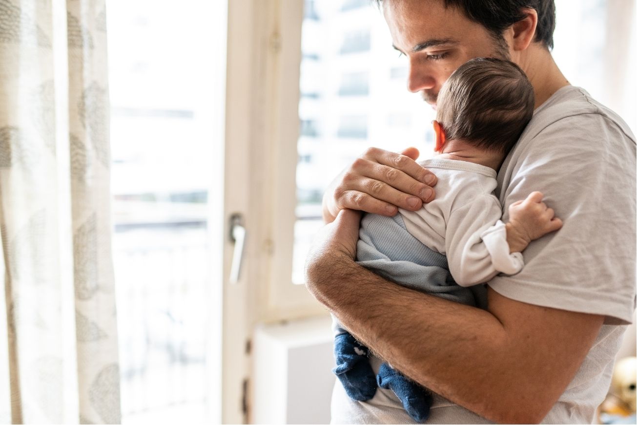 Father holds a small baby
