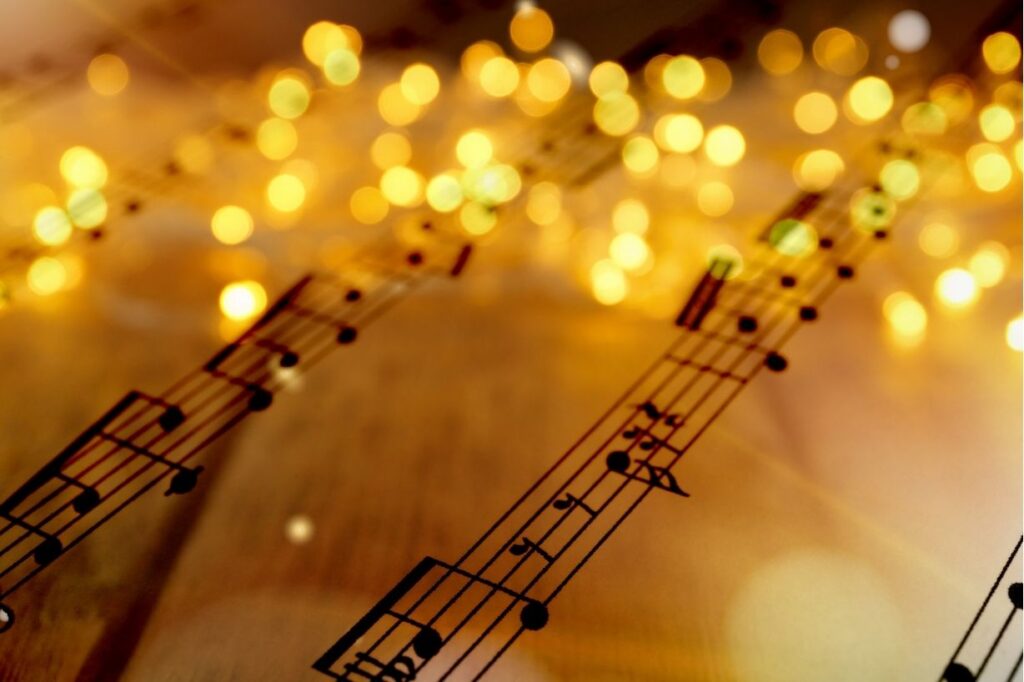 Sheet music and gold holiday lights